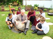 Rev Philip Broderick demonstrates hang drum during Quiet Garden launch - image JS