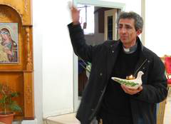 Father Raed Abusahlia, Catholic priest in the village of Taybeh, presents a Peace Lamp to  Living Letters team. Photo: Emma Halgren/WCC