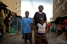 Margaret and children in Nairobi slum. Photo: Frederic Courbet
