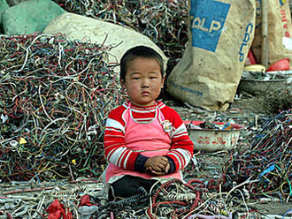 A child at an electronics waste disposal site in Guangdong province, China. Picture: Greenpeace, China