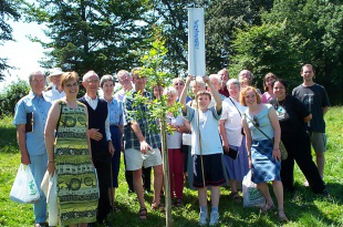 Fr Pat Davies - fourth from left - with members of the Westminster  Diocese Justice and Peace Commission, planting a tree on a sunny day at the National J&P Peace Conference in Derbyshire in July 2003
