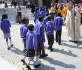 Bishop John greets children
