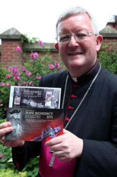  Archbishop  Longley with the miniature sheet and presentation pack. Picture by Peter Jennings