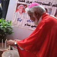 Bishop Joseph Coutts lights candles for victims