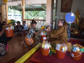 Children bring presents to temple