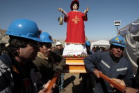 Chilean miners with statue of St Lorenzo, their patron saint