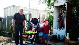 Grandad with children by one of the Dale Farm shrines - pic: JS/ICN