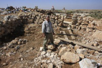 Villager in remains of animal shelter