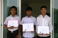 Three friends show their  college diplomas