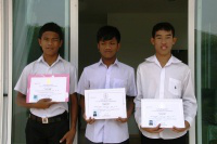 Three friends show their college diplomas
