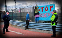 activists put  banner on fence