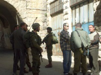 Soldiers & plainclothed officer interview Hebron shopkeeper