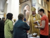 Bishop Séamus helps distribute crosses and prayer cards