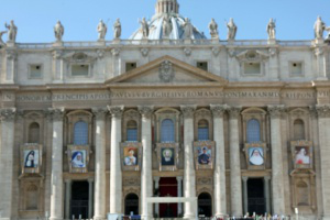 Tapestries of the seven new Saints draped on the front of Saint Peter's Basilica