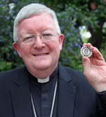Archbishop Longley with Seychelles coin