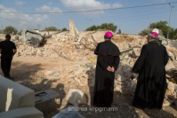 Patriarch surveys demolished home