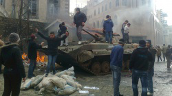 Young Syrians clamber on abandoned tank