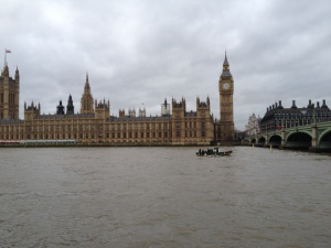 refugee boat dwarfed by Houses of Parliament