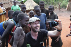 Ben poses for selfie with children