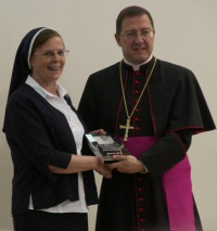 Sr Hannah Dwyer receives award from  Bishop John Sherrington