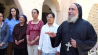 Coptic Bishop Thomas with parishioners - image Andrew Bpyd