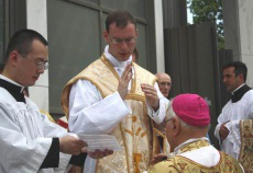 Fr. Kenneth Walker, FSSP gives a first blessing to Bishop Bruskewitz in 2012