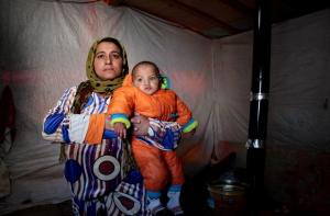 Syrian mother & child in freezing tent, Bekaa Valley.  Photo: Jean Khoury Caritas/CLMC