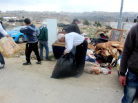 Idris family collecting their belongings after demolition. (Beit Hanina, 2014)