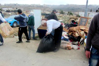 Idris family collecting their belongings after demolition. (Beit Hanina, 2014)