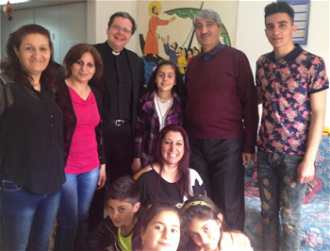 Fr Dominic with refugees at Our Lady\'s Mount Refugee Centre. Image: Leslie Giltz  