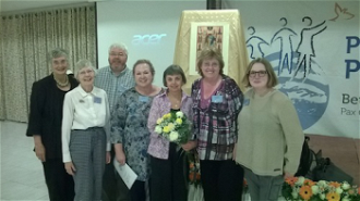 Group from UK Pat Gaffney with flowers, writer Ellen Teague 2nd from right