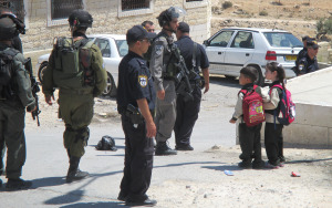 Soldiers frighten children on their daily walk to school 