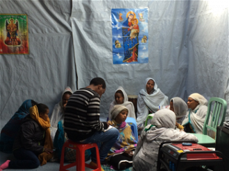 Eritrean refugees praying in Calais 'jungle' - image ICN