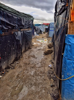 Makeshift shelters in a river of mud