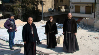 Bishop Khazen, front, with other clergy on visit to bombed area