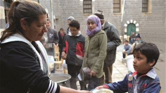 Distributing aid in Homs church compound