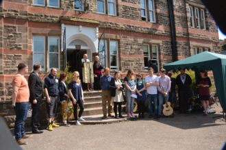 Archbishop Longley with volunteers on steps of Soli