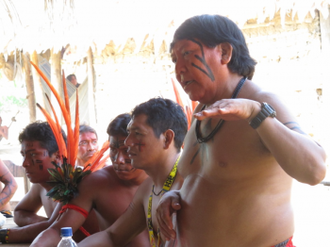 Davi Yanomami, president of CAFOD partner, Hutukara Yanomami Association, speaks to the Yanomami community, Ajarani, about the land threats they face and raises awareness of their rights'. Credit: CAFOD