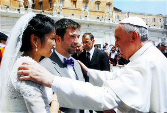 Pope Francis with a newly married couple