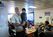 Captain Joop with a child refugee