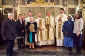 Bishop McAleenan with hospital chaplains holding lanterns with the deceased children's names in Holy Souls Chapel.