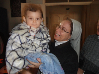 Sr Annie Demerjian with child in Aleppo