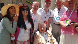 Charles and Sue Whitehead, with Myles Dempsey (in wheelchair) in St Peter's Square and other participants