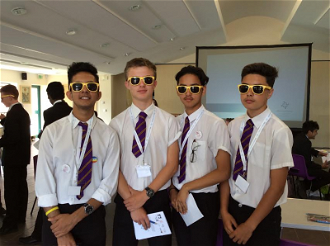 Students model sunglasses from their delegate packs