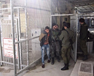 Palestinian boy stopped at a checkpoint