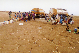 South Sudan refugees queuing for aid in Sudan - image ACN