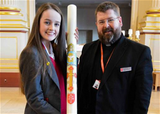Year 9 student, Niamh Wright, with School Chaplain, Fr Lee Bennett and Paschal Candle