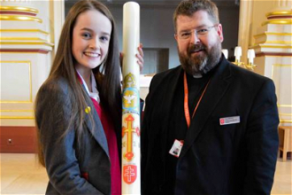 Year 9 student, Niamh Wright, with School Chaplain, Fr Lee Bennett and Paschal Candle