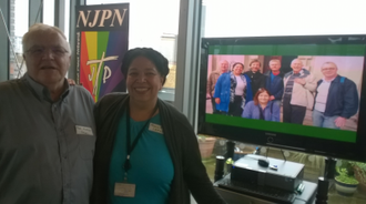 Phil Kerton and Maria Elena Arana showing photos from NJPN archives.