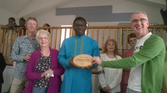 CAFOD's Tony Sheen handing over the award plaque